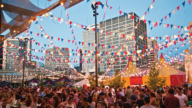 Crowds of people socialising in Victoria Square, Adelaide.